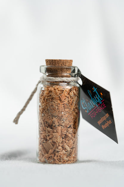 Glass Bottle Filled with shavings and stardust from the original 1969 Woodstock stage wood- Peace Of Stage LLC- {{Product type}}