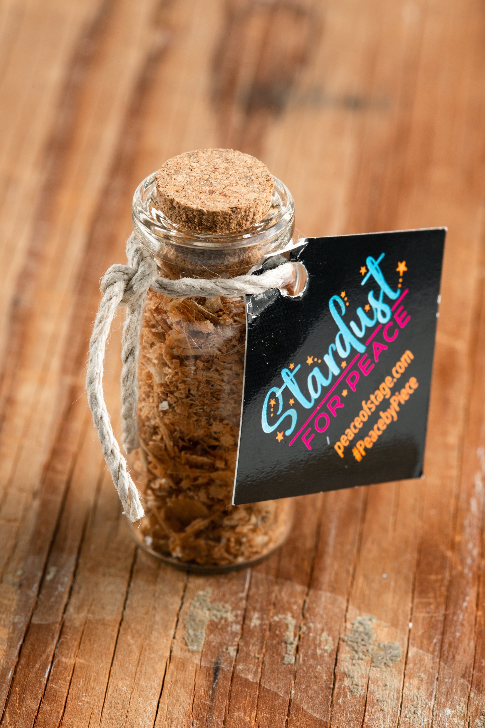 Glass Bottle Filled with shavings and stardust from the original 1969 Woodstock stage wood- Peace Of Stage LLC- {{Product type}}